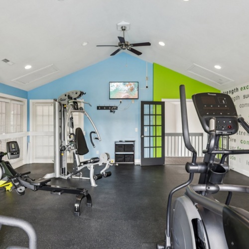 Apartment fitness center with green and blue walls