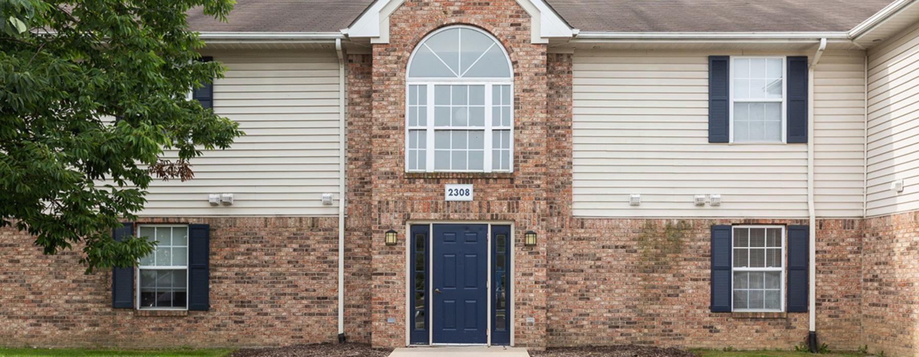 a brick building with a blue door