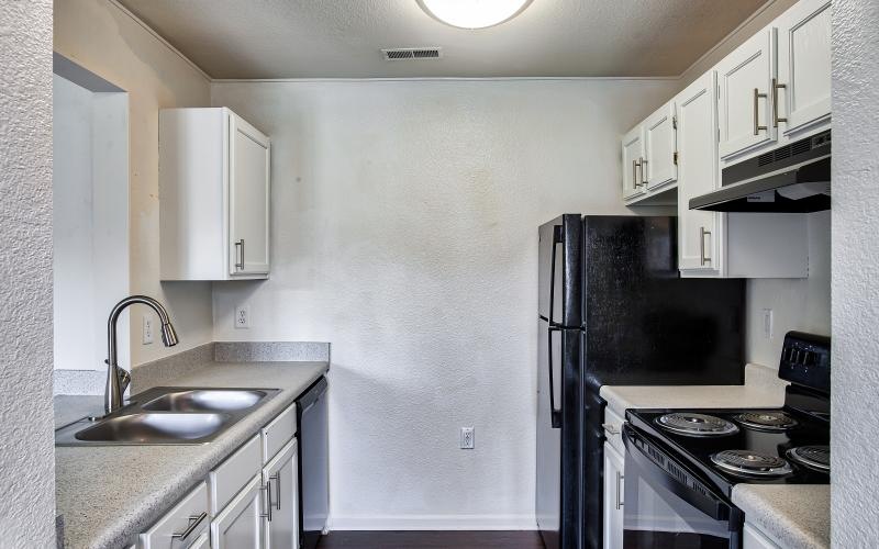 a kitchen with white cabinets